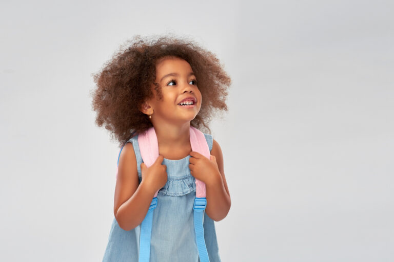 happy little african american girl with backpack